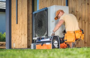 hvac,worker,working,on,a,modern,heat,pump,outside,a